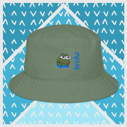 Pepe the Frog bucket hat in green with high-quality embroidery of Pepe wearing blue shirt, paired with the word 'broke' in bold blue stitching. Trendy streetwear accessory for meme enthusiasts, perfect for casual outfits and internet culture fans.