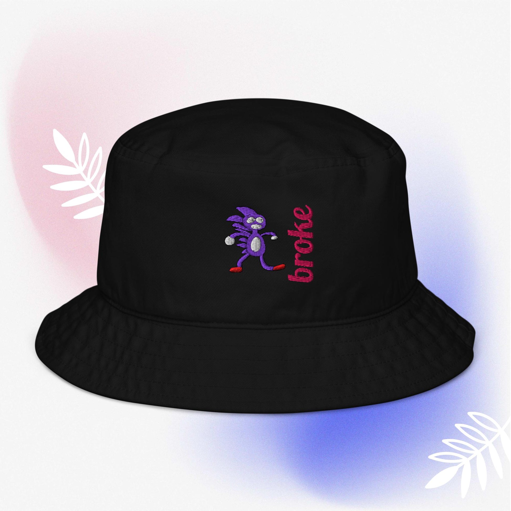 Beige bucket hat featuring a purple Sanic embroidery, a quirky version of Sonic the Hedgehog, alongside the word 'broke' stitched in bold red. Perfect for meme culture fans and streetwear enthusiasts looking for a playful and trendy accessory.